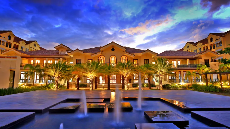 Amalfi clubhouse and courtyard illuminated in the evening