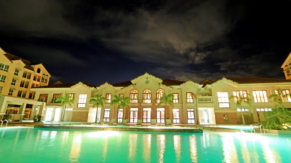 Amalfi resort pool and clubhouse illuminated at night