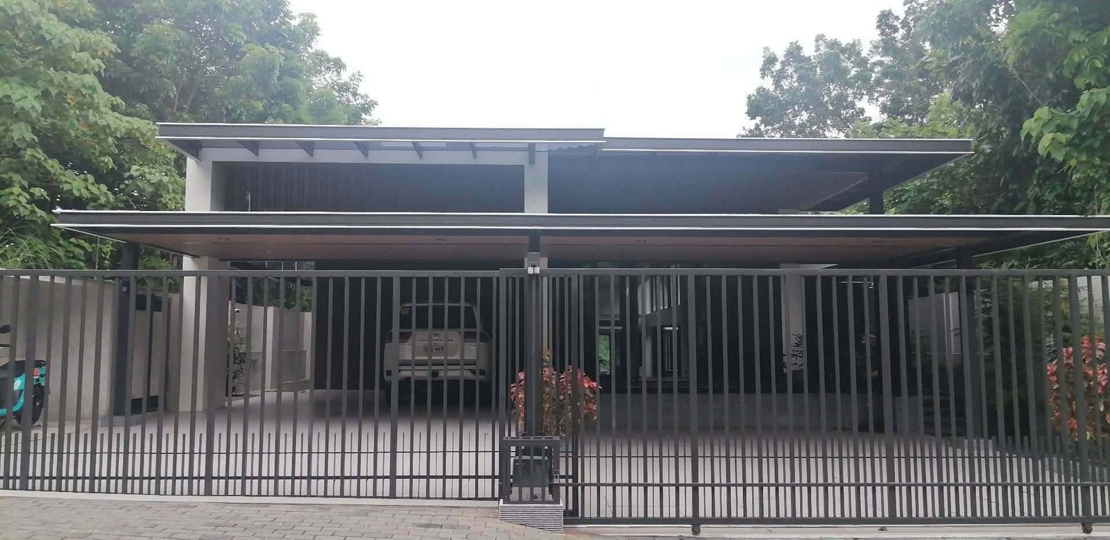 Street frontage of a modern five-level residence in Maria Luisa Estate Park, Cebu City, with automated gate and covered multi-car garage